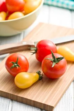 Tomatoes on cutting board Stock Photos