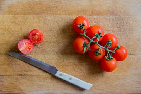 Tomatoes on cutting board Stock Photos
