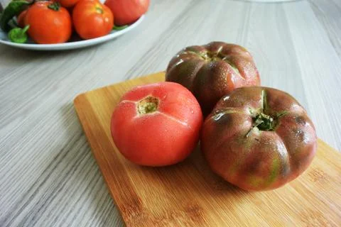 Tomatoes on cutting board	 Stock Photos