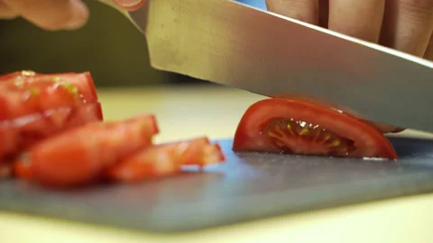 Tomatoes cutting process. A man holds a vegetable in his hands. Stock Footage 135837423