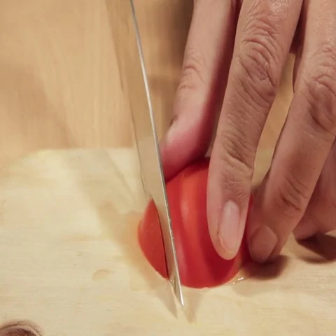 Tomatoes cutting on white board Stock Footage 69461381