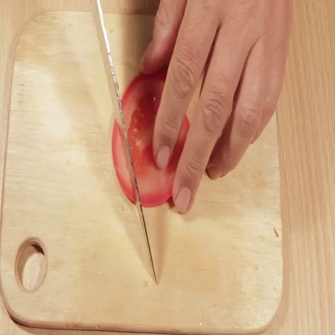 Tomatoes cutting on white board Stock Footage 69461602
