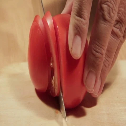 Tomatoes cutting on white board Stock Footage 69461697