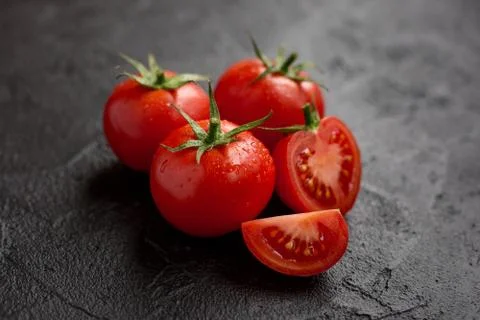 Tomatoes on dark background Stock Photos