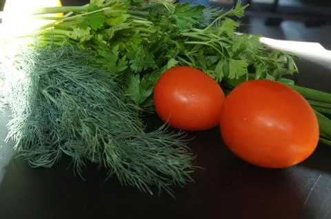 Tomatoes with dill on the board Stock Photos