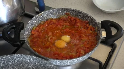 Tomatoes with eggs for breakfast in a pan on the stove, Turkish melemen dish, Video stock 201268355