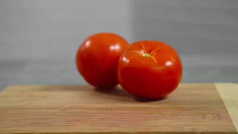 Tomatoes fall and roll towards each other Stock Footage 196725801