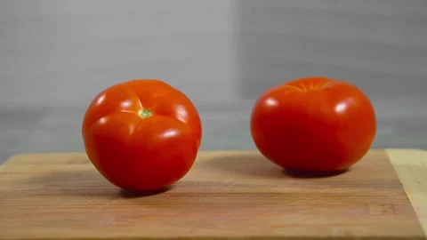 Tomatoes fall and roll towards each other Video stock 196725810
