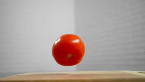 Tomatoes fall and roll towards each other Stock Footage 196725814