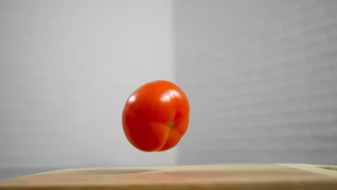 Tomatoes fall and roll towards each other Stock Footage 196725816