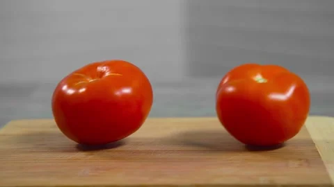 Tomatoes fall and roll towards each other Stock Footage 196725826