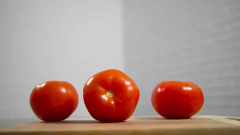 Tomatoes fall and roll towards each other Stock Footage 196725840