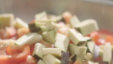 Tomatoes fall eggplants into a hot frying pan Stock Footage 198936686