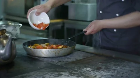Tomatoes Fall into Frying Pan Stirring Stock Footage 78594780