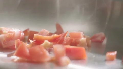 Tomatoes fall into a hot pan Stock Footage 198005208