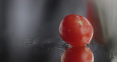 Tomatoes fall on a mirror surface with water Stock Footage 197866208