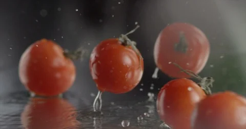 Tomatoes fall, rotate and push each other on glass in Slow motion (Few shots). Stock Footage 95244026