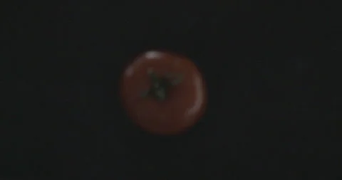 Tomatoes fall on the table Stock Footage