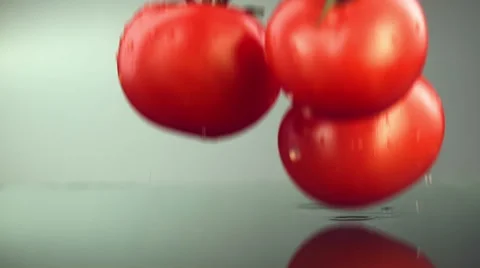 Tomatoes falling on a smooth surface Stock Footage 49641346