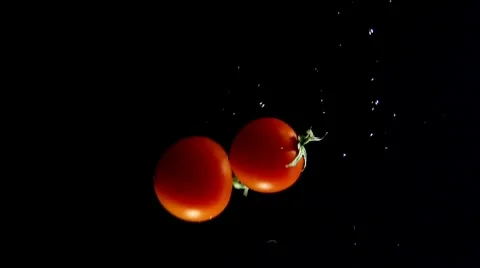 Tomatoes falling into water Stock Footage 8573503