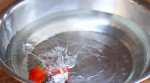 Tomatoes falling into the water Stock Footage 66789569