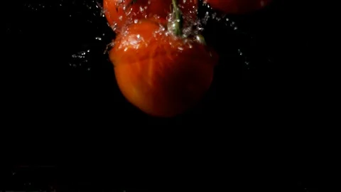 Tomatoes falling into water. 스톡 동영상 97592854