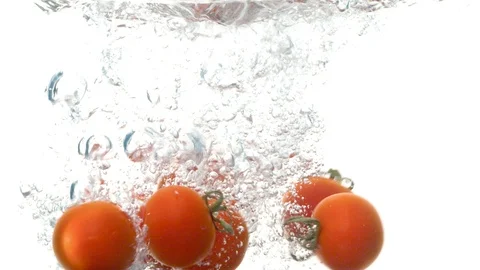 Tomatoes falling into the water Stock Footage 123654801