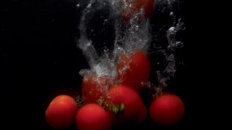 Tomatoes falling into the water Stock Footage 123725153