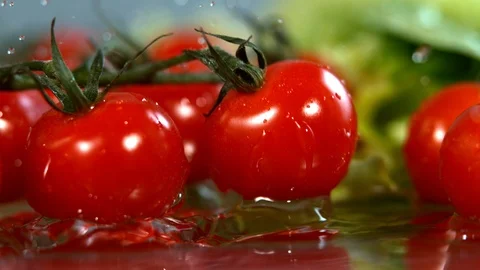 Tomatoes falling to water in super slow motion, shot with high speed cinema Stock Footage 101296711
