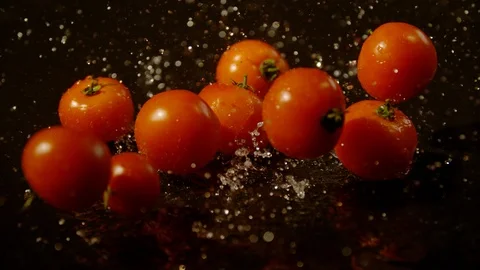 Tomatoes falling on a water surface, Ultra Slow Motion Stock Footage 86585517