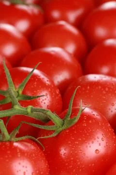 Tomatoes forming a background and with copyspace Stock Photos