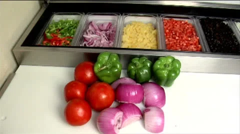 Tomatoes, green peppers and red onions at prep station, static shot Stock Footage 24632704