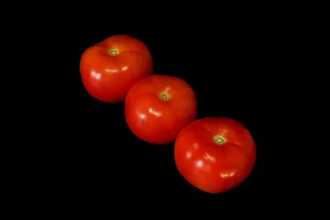 Tomatoes isolated on black background Stock Photos
