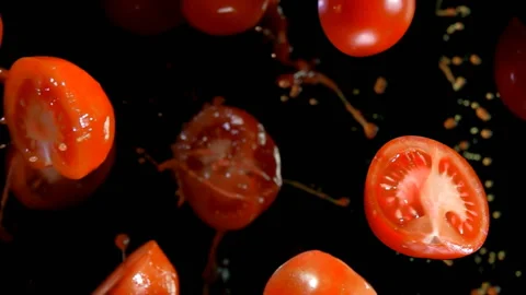 Tomatoes with juice flies to the camera Stock Footage 87379156