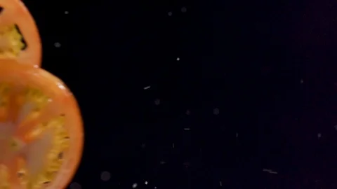 Tomatoes jumping in the air with drops of water jumping around Stock-Footage 128786487