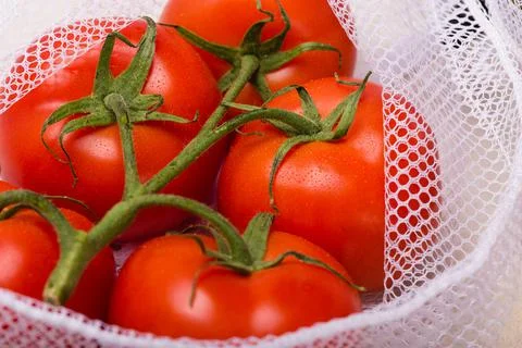 Tomatoes on the kitchen table close up Photos