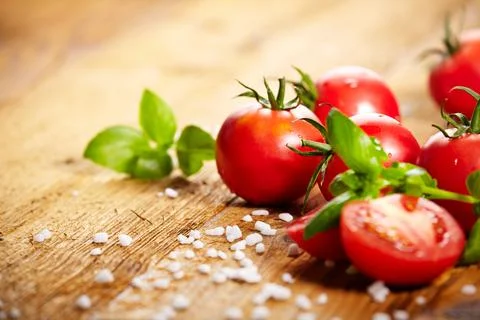 Tomatoes lying on old table. Diet food Stock Photos