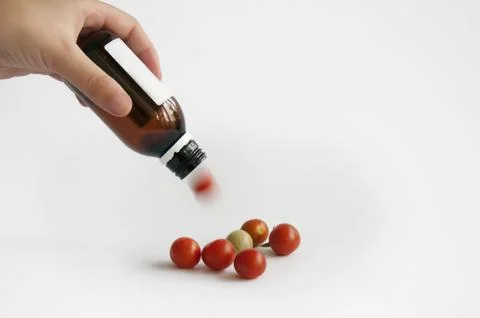 Tomatoes from the medication bottle Stock Photos