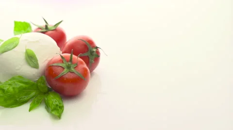 Tomatoes, mozzarella and basil on white background Stock Footage 54770002