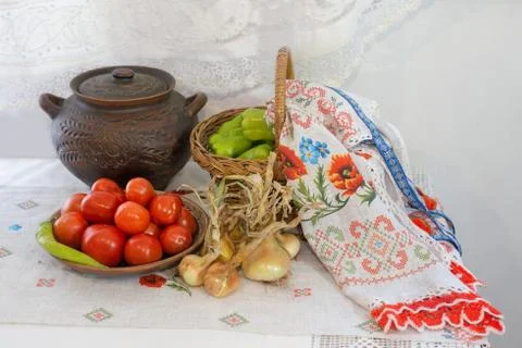 Tomatoes, onions, bell peppers, towel and earthen pot. Stock Photos