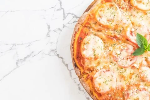 Tomatoes pizza on table Stock Photos