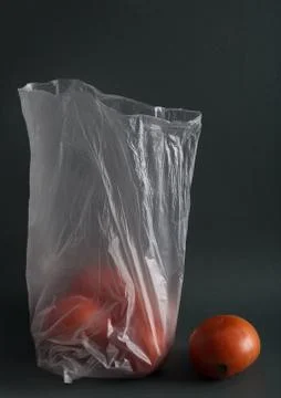 Tomatoes in plastic bag on a dark background 写真素材