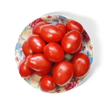 Tomatoes on plate Stock Photos