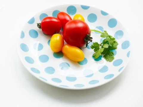 Tomatoes on a plate Stock Photos