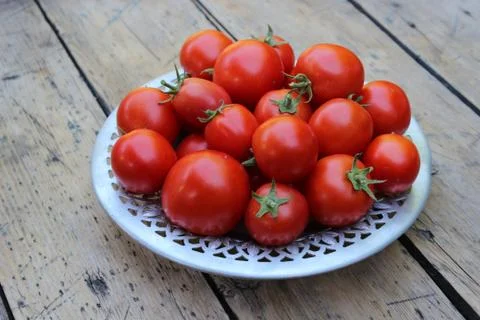 Tomatoes on plate Stock Photos