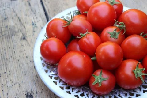 Tomatoes on plate Stock Photos