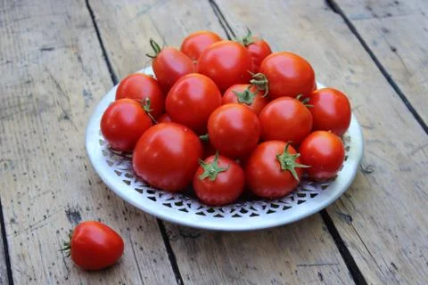 Tomatoes on plate Stock Photos