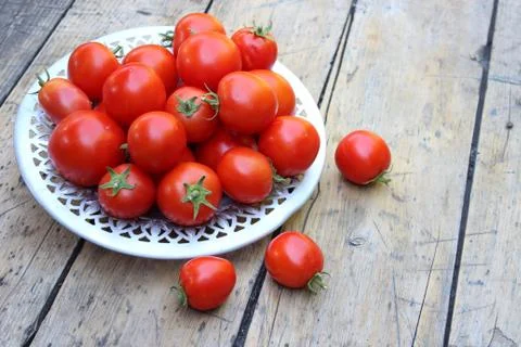 Tomatoes on plate Stock Photos