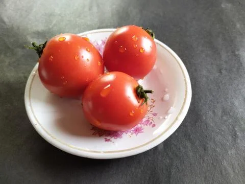 Tomatoes on a plate. Stock Photos