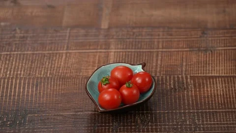 Tomatoes on a plate studio shot Stock Footage 183502291